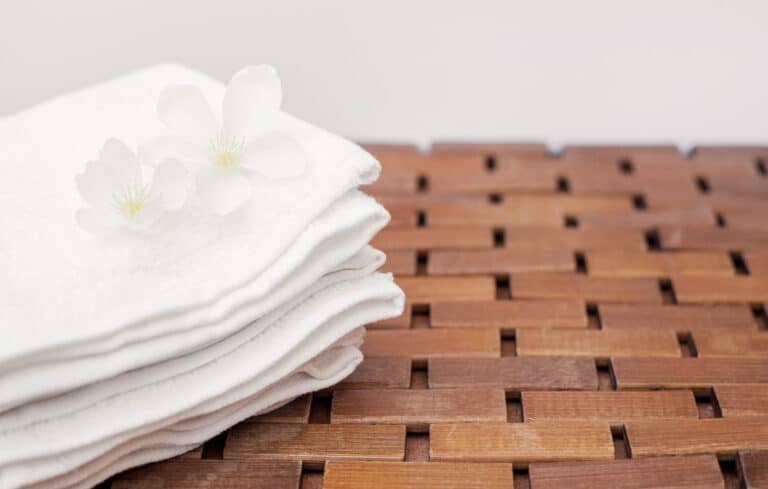 close up white flowers towel wooden tabletop